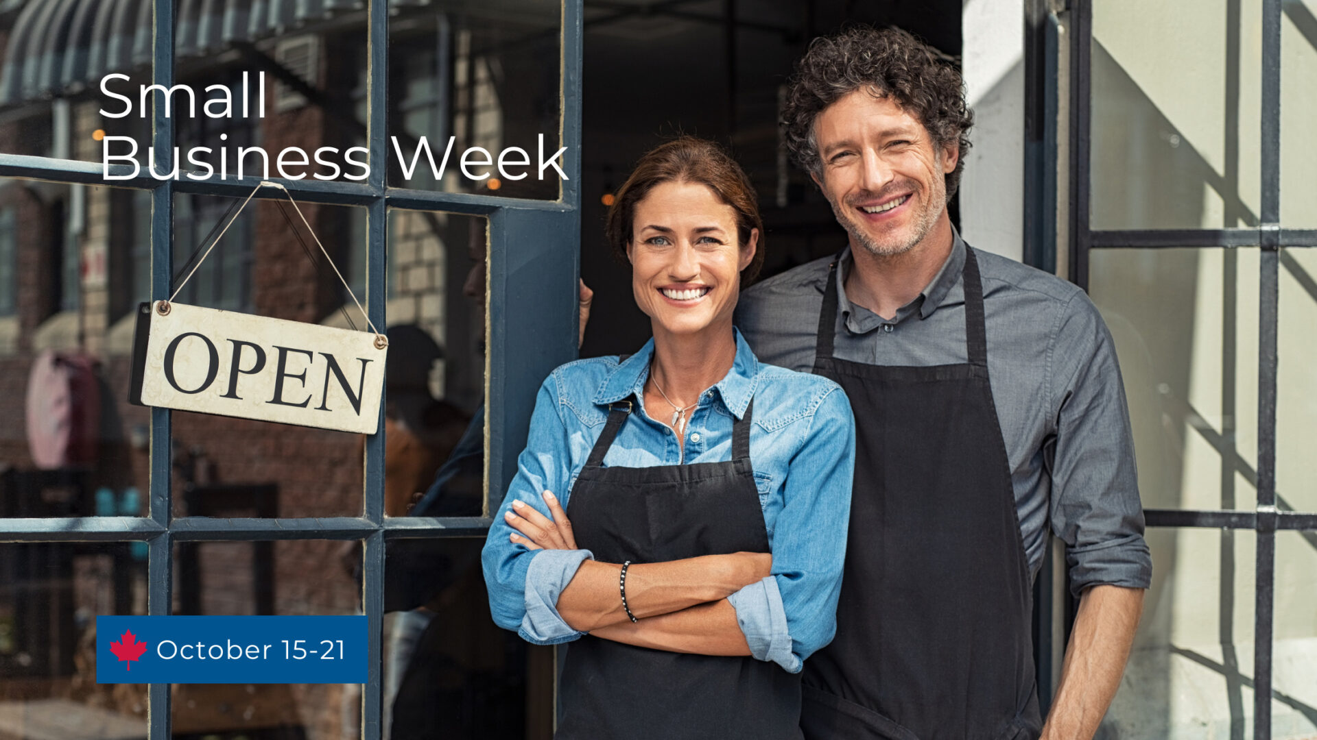 Business owner standing outside their store with an open location.